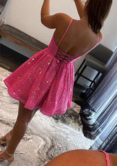 Back view of a pink Sequined Homecoming Dress with spaghetti straps lace up open back and flared short A line skirt