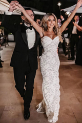27Dress lace wedding dress worn by bride dancing with groom in black tuxedo at wedding celebration