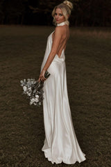 27dress elegant white sheath wedding dress with open back and halter neckline on bride outdoors