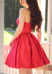 27Dress red strapless satin fit and flare Sleeveless Homecoming Dress knee length shown from back with long wavy hair