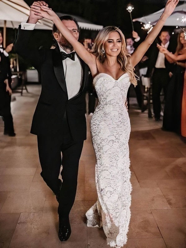 Bride wearing a strapless lace wedding dress by 27Dress dancing with groom at wedding reception